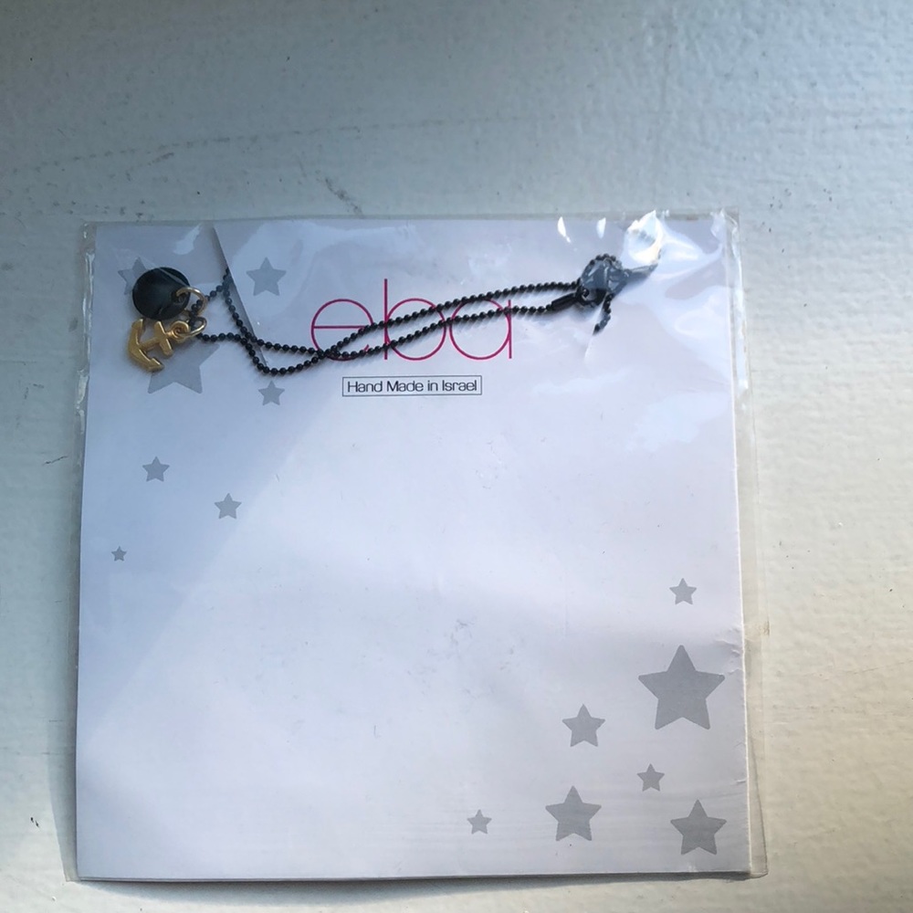 A black and gold necklace With packaging